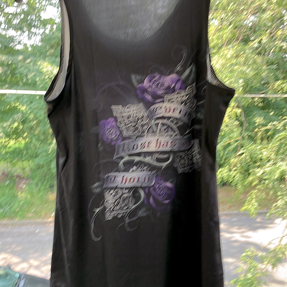 Woman’s sleeveless top. Says every rose has a thorn.